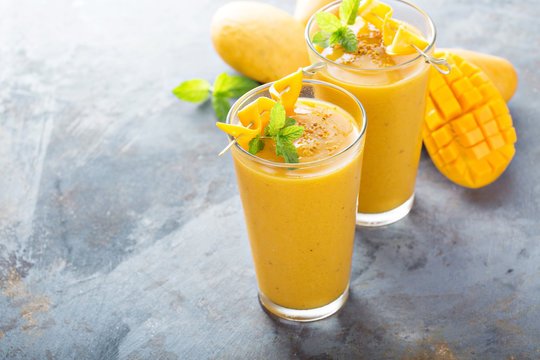 Creamy homemade mango shake served in a chilled glass with fresh mango pieces and mint leaves