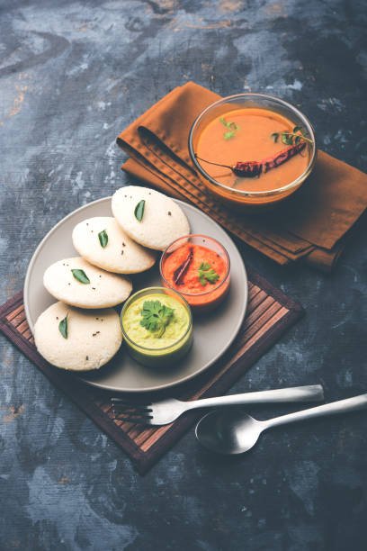 Soft steamed idlis served with coconut chutney and sambar