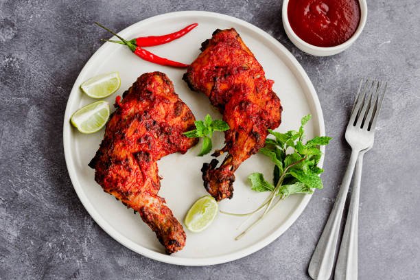 Juicy tandoori chicken grilled with Indian spices and served with onion rings and lemon